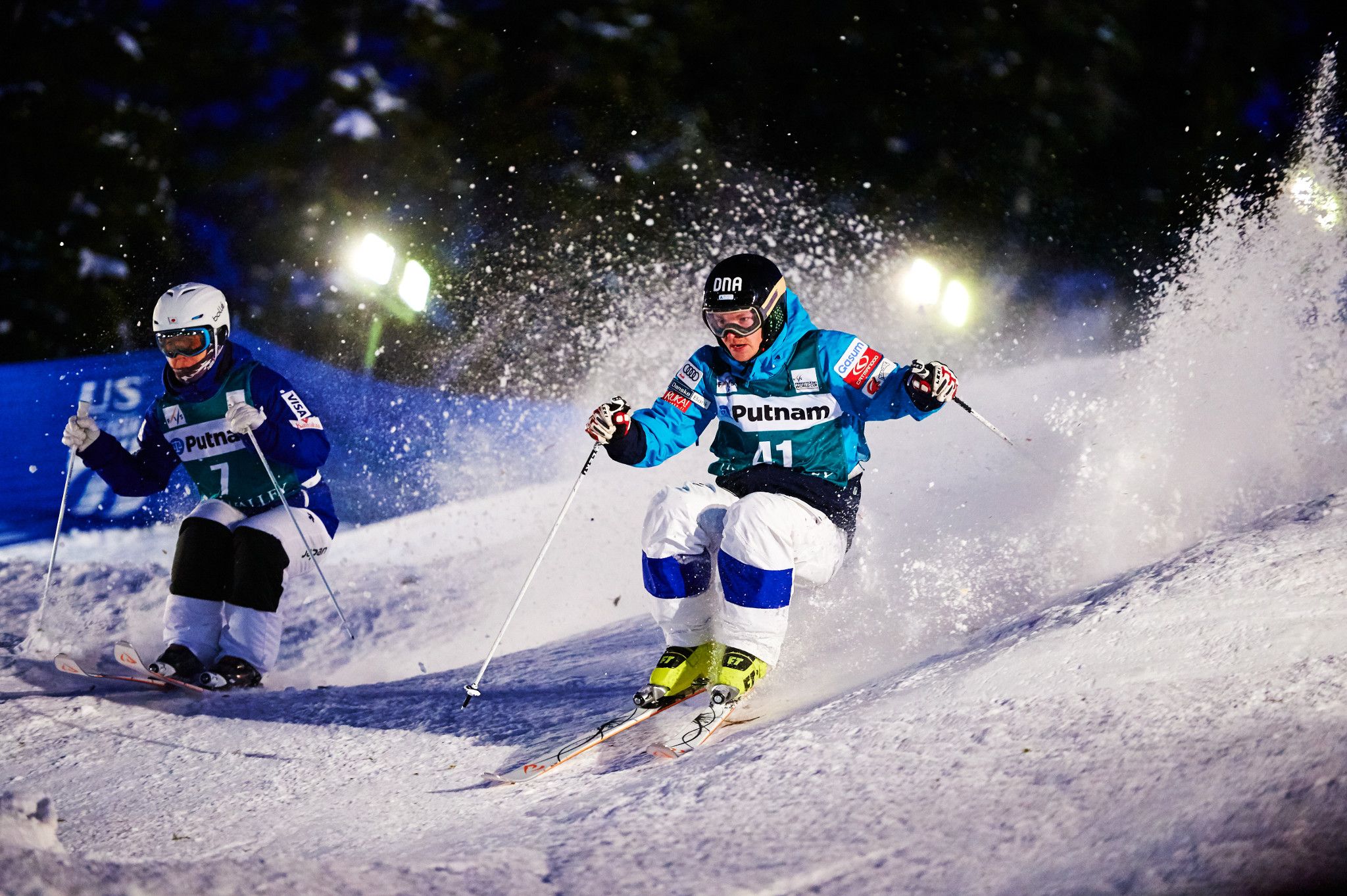 Two male skiers racing down Champion Ski Run at Deer Valley Resort.